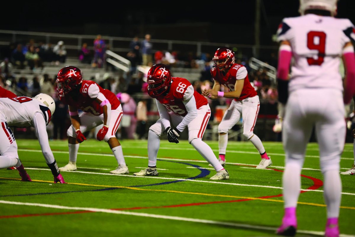 Senior Noah Lenn sets up to recieve the snap from the center against the Justice Wolves during a regular season game, 10/10